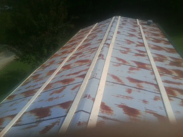 Rusted metal roof panels with new wood purlins before replacement — Storm Damage Roof Repair in Hoboken by Roofing Brothers