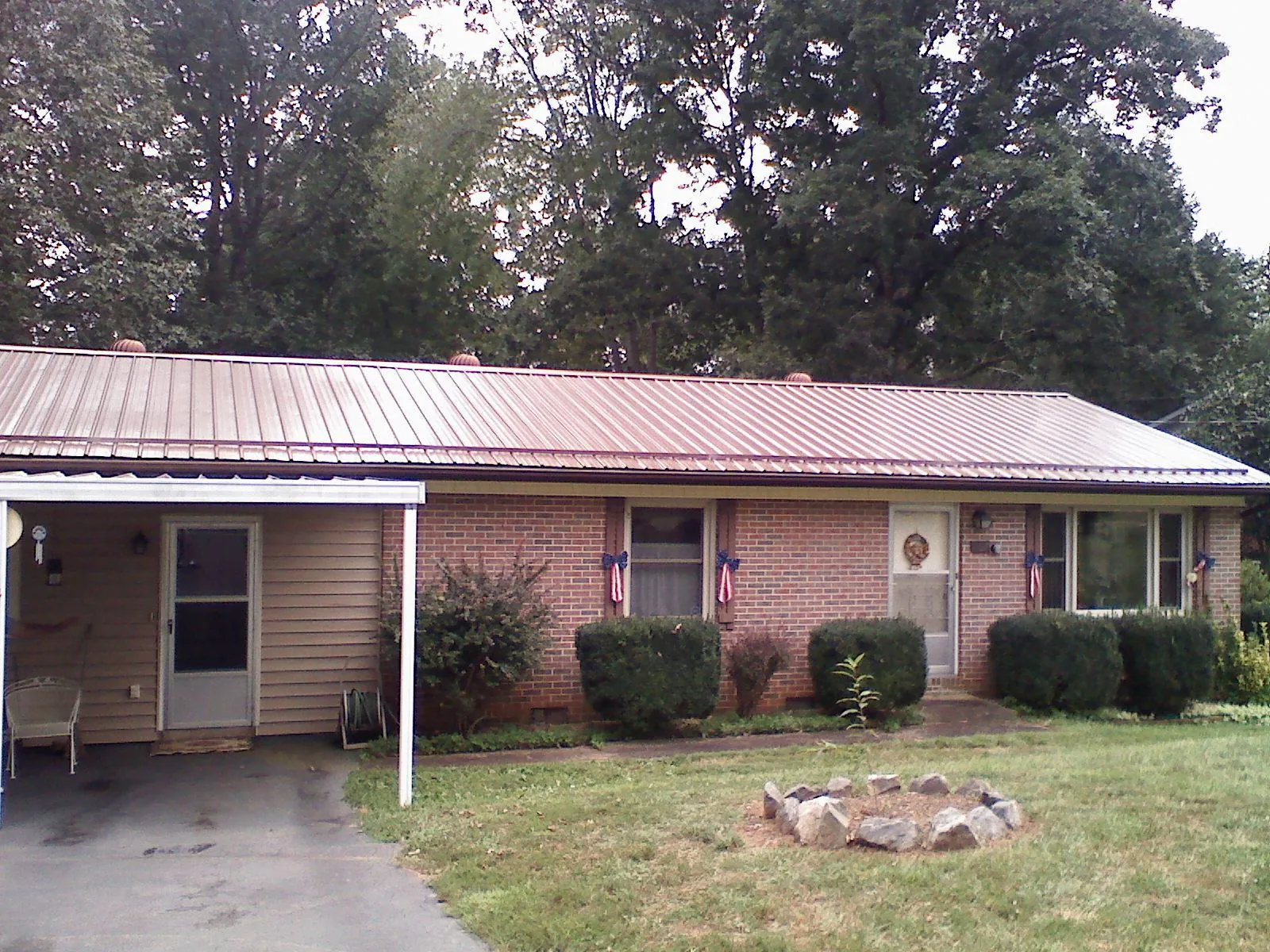 Bronze metal roof and carport on a brick ranch home — Roof Repair work by our crew in Hoboken